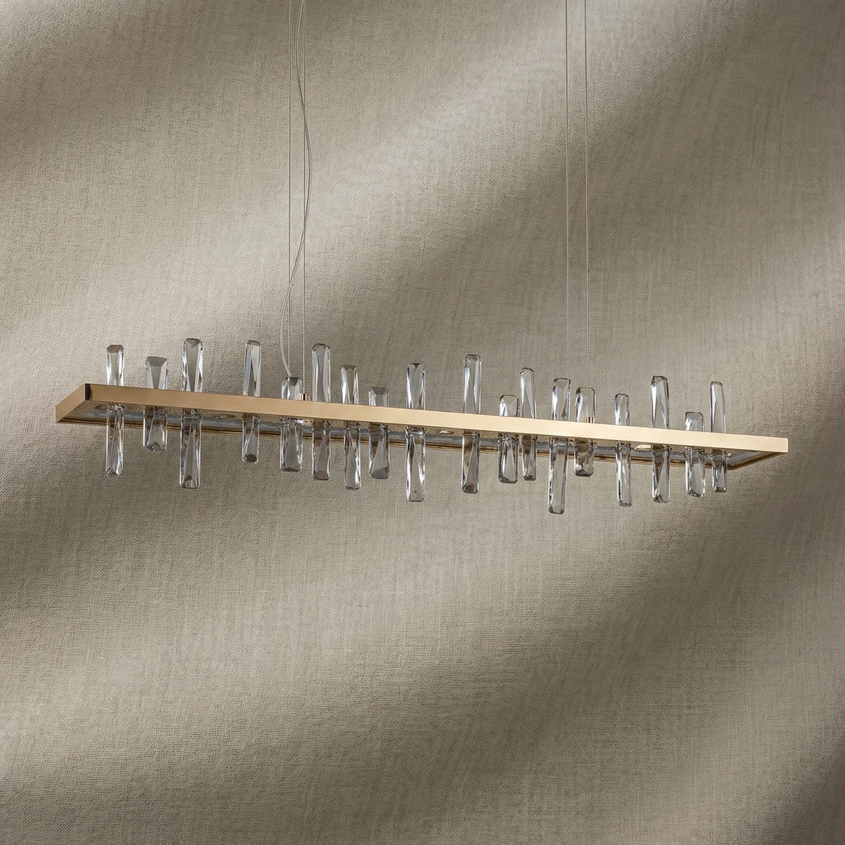 Yiosi Nora 47 inch linear crystal pendant chandelier in modern American dining room with warm glow