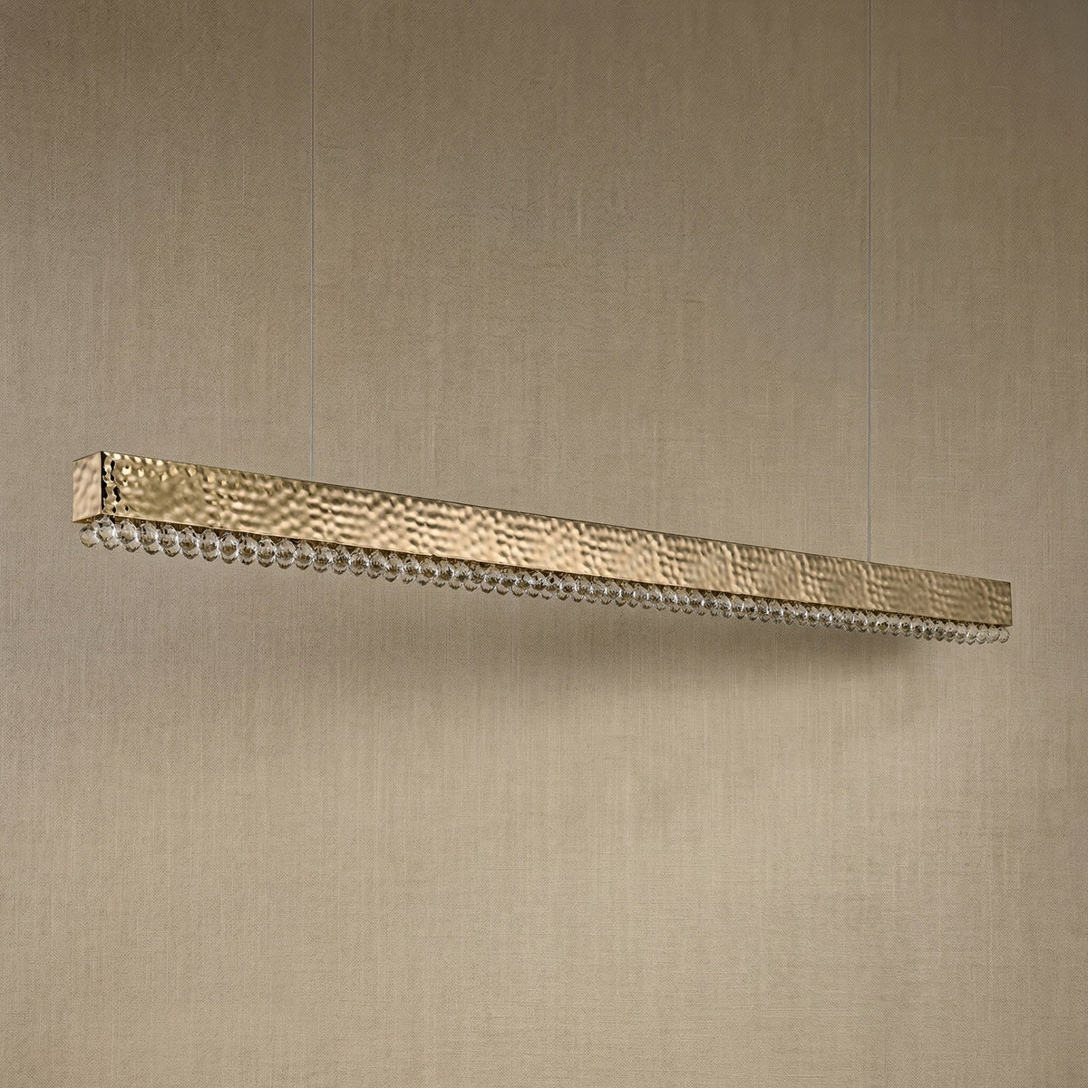 Yiosi Hudson 50 inch linear crystal bar chandelier in modern American dining room with warm glow