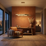Modern dining room 54 inch linear crystal chandelier over long wooden table — Yiosi Drake antique brass