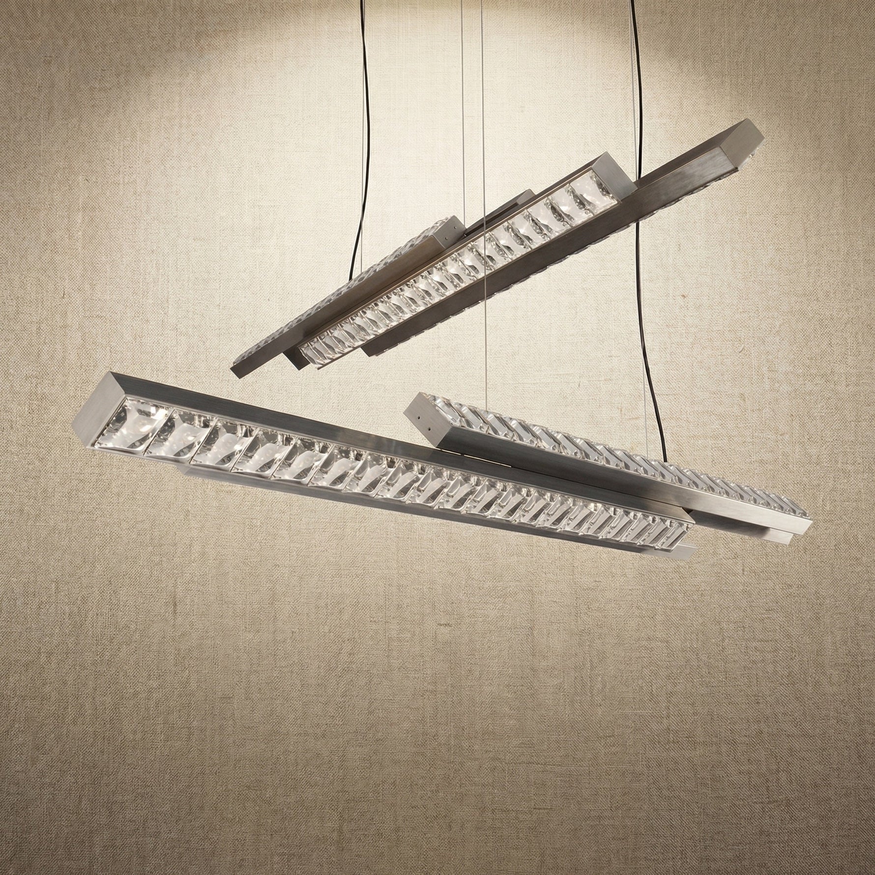 Yiosi Drake 63 inch linear crystal chandelier in modern American dining room with warm ambient glow