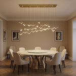 Cascading handmade glass pendant over kitchen island with marble countertop — Yiosi Crane linear chandelier