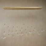 Yiosi Crane handmade cascading glass linear chandelier with antique brass finish — modern dining pendant