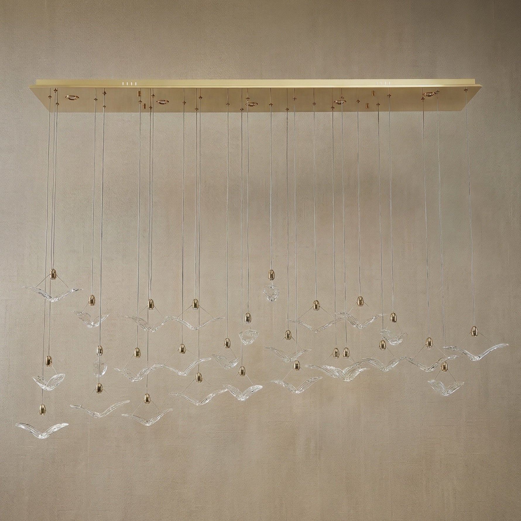 Yiosi Crane handmade cascading glass linear chandelier with antique brass finish — modern dining pendant