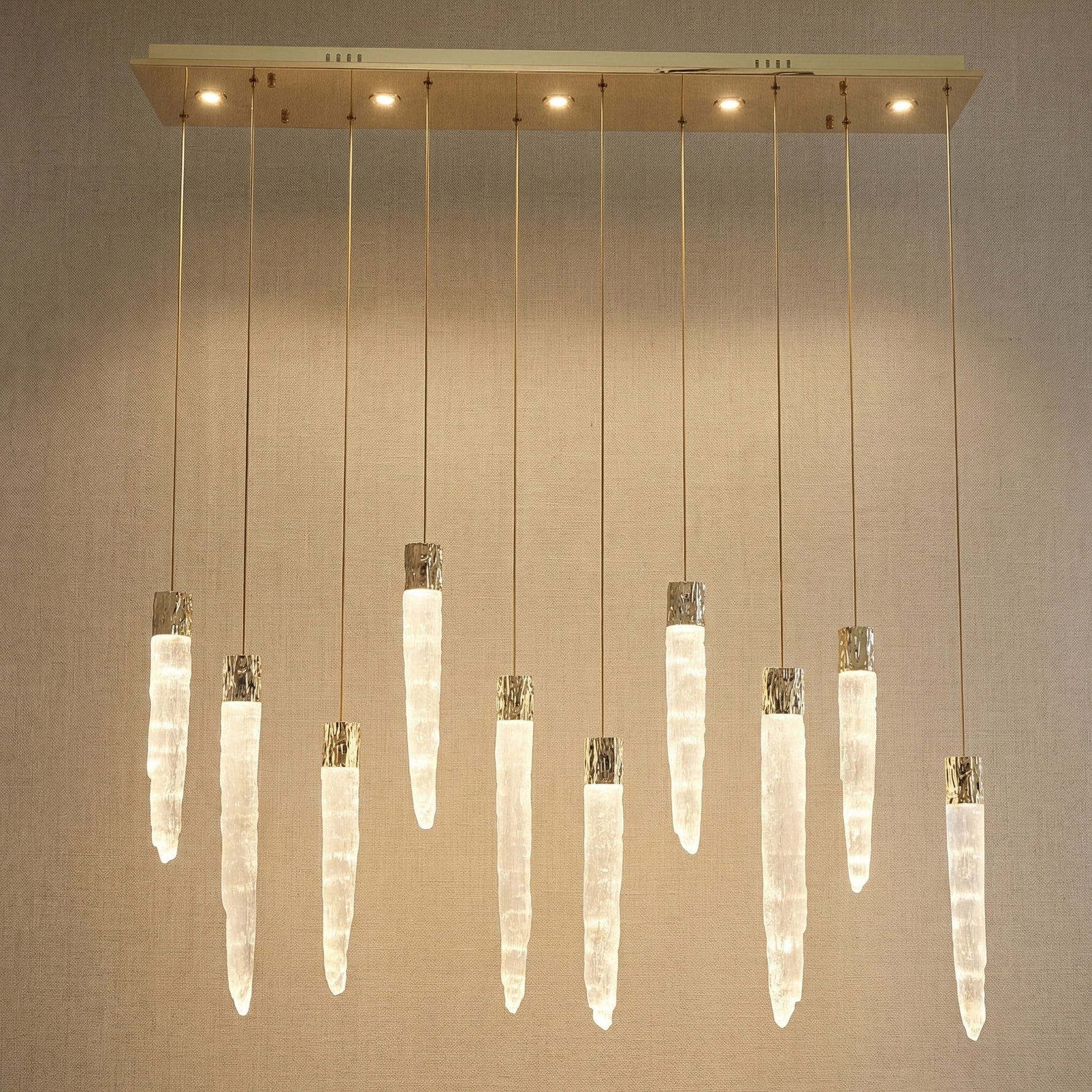 Modern dining room with K9 crystal icicle linear chandelier over long wooden table — Yiosi Halsey 47 inch
