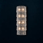 Yselle Chrome Tiered Glass 8-Light Wall Sconce 7.1" on a deep teal-blue wall