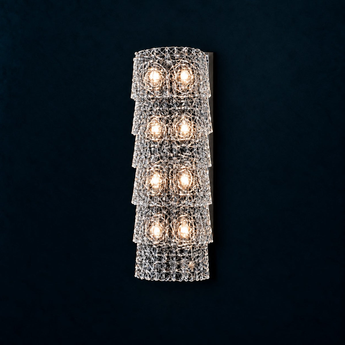Yselle Chrome Tiered Glass 8-Light Wall Sconce 7.1" on a deep teal-blue wall